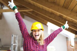 blonde woman overjoyed with construction helmet
