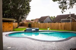 outdoor backyard with pool deck and wooden fance