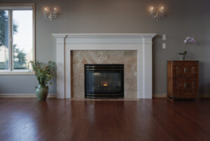 fireplace with tile around it and wood floor